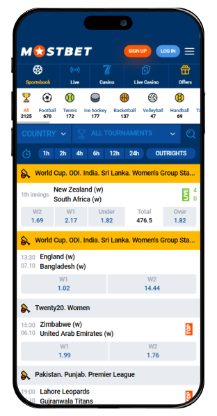 A phone with the main page of the Mostbet website open